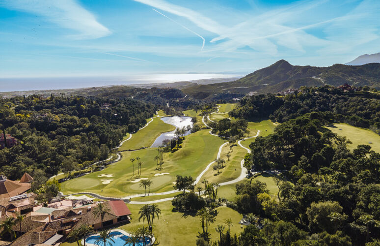 the view. Sea, golf course, mountains. The house is in here somewhere.